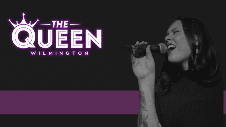 A Rylynn Woods passionately sings into a microphone against a dark background. To the left, text reads "The Queen Wilmington" in bright purple letters.